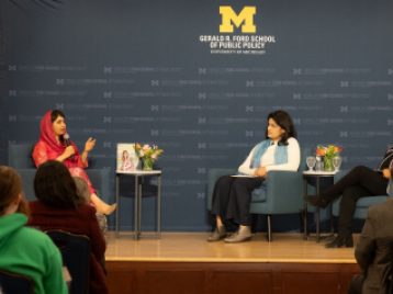 Three women on stage in conversation