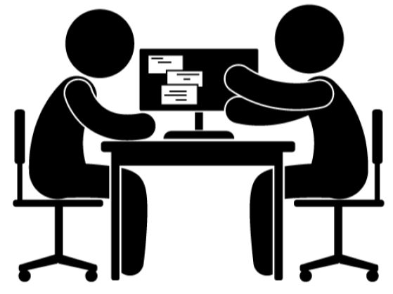 Two people chatting at a desk