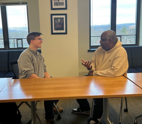 Two men talking at a table. 