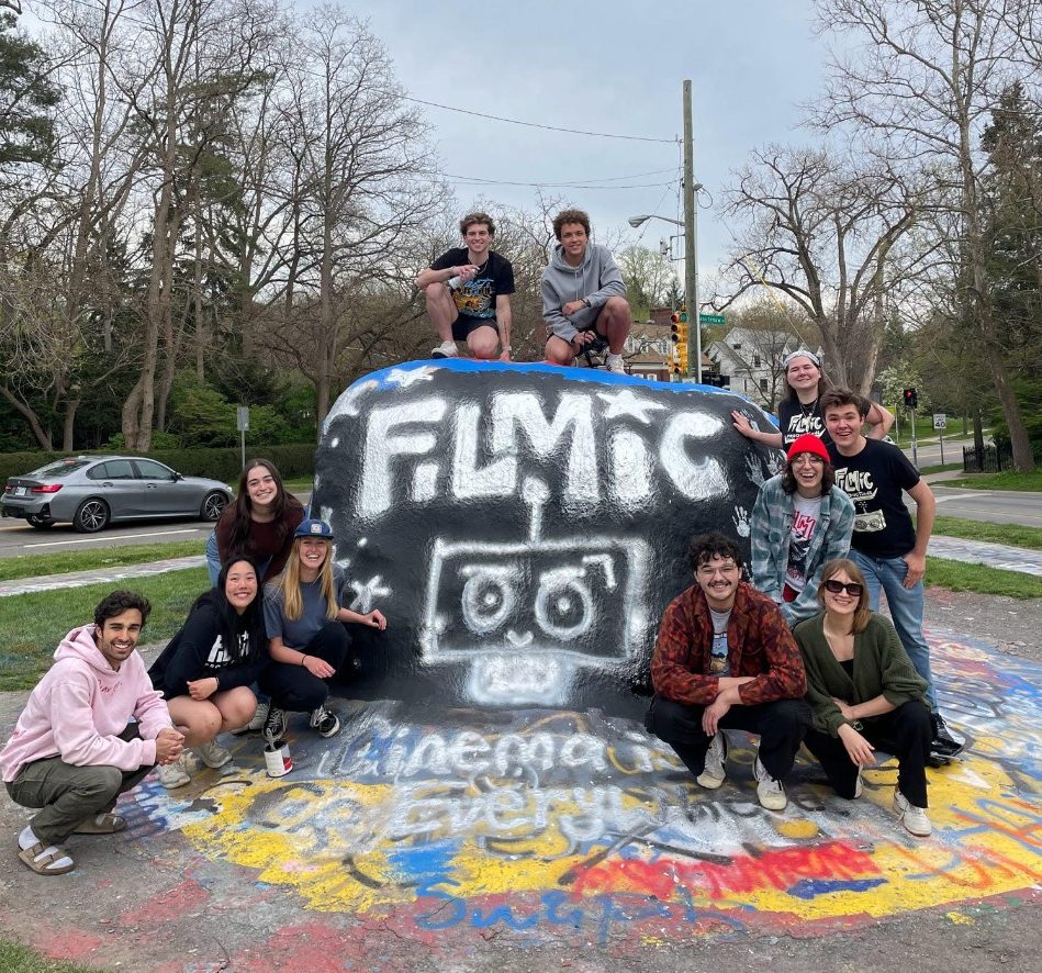 FIlmic painted on the UM rock with members surrounding it