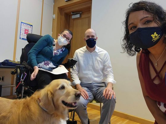 GSP staff Ashley and her service dog, Reason; Benjie; and Nita pose for a selfie during the Fall Leadership Retreat