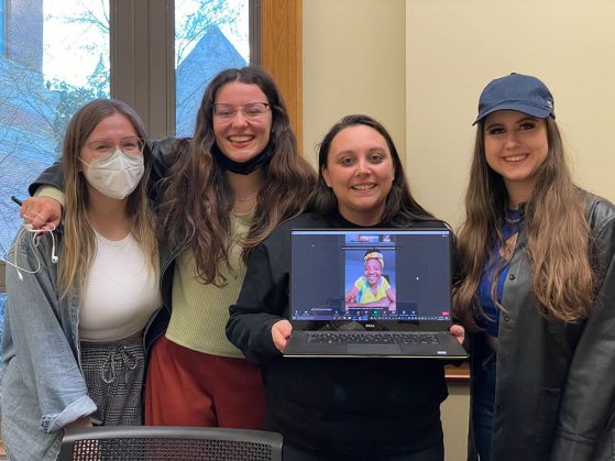 Student Engagement Coordinator Sarah Sujkowski and members of the GSP Blog Team, Lea Garzotto, Lacey Kirchen, and Magda Wojtara hold up a virtual Yaera Spraggins at their final team meeting