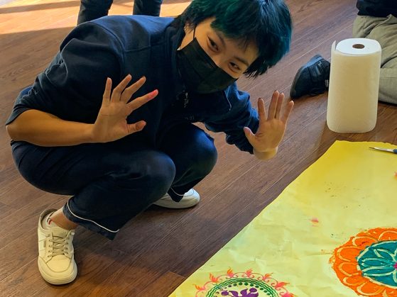 RA Zoe Zhou shows off her rangoli at the Diwali celebration