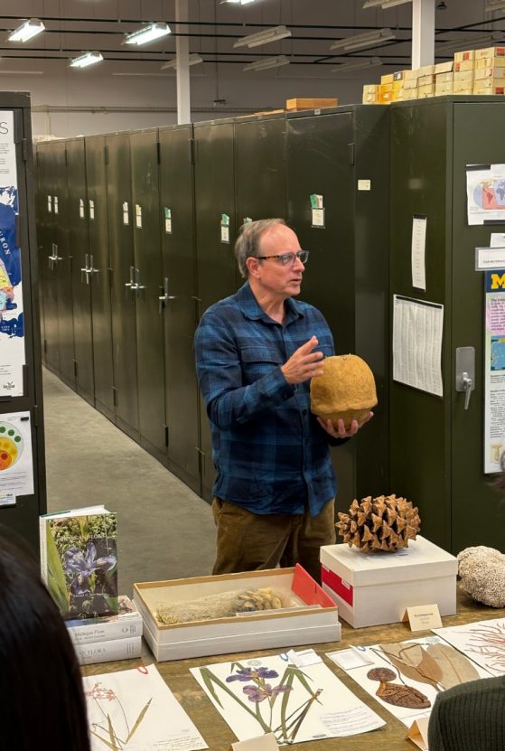 Curator Chris Dick Showing a Specimen