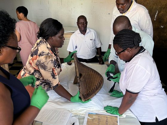 A group of people working on a shield. 