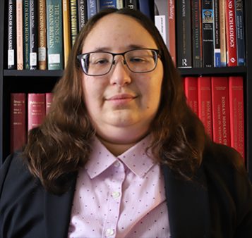 Portrait of Caroline Nemechek in front of bookcase