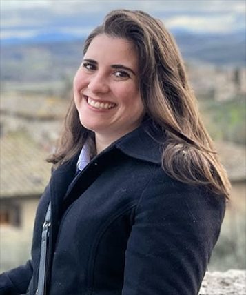 IPAMAA graduate student Amelia Eichengreen stading before an Italian landscpae