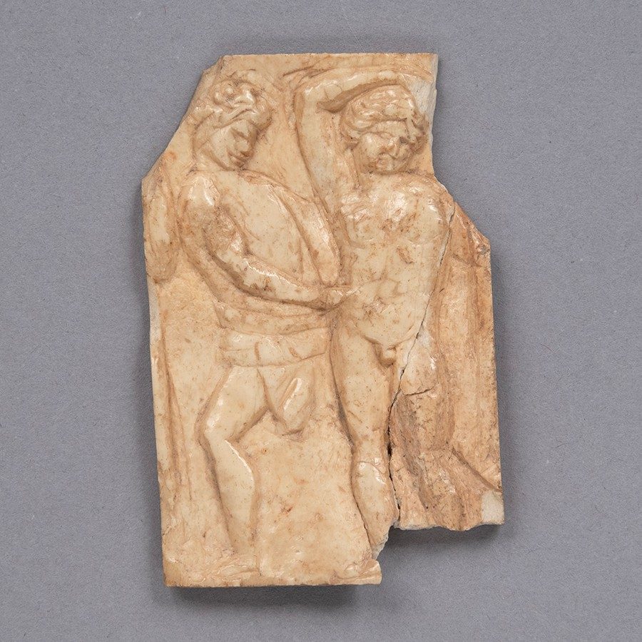 White-brown, rectangular piece of ivory with carvings of two men.