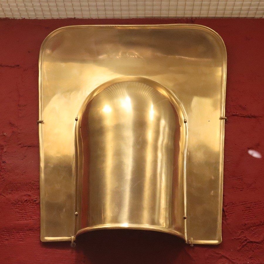 Brass guard with a rounded space for one’s shoulder.