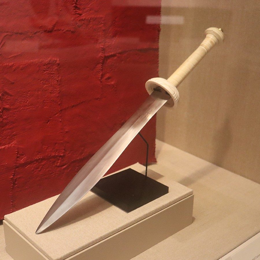 Straight steel blade with a wooden handle.