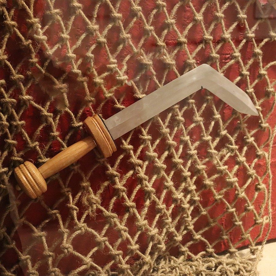 Steel blade with a wooden handle. The last several inches of the sword curve at a 45-degree angle.