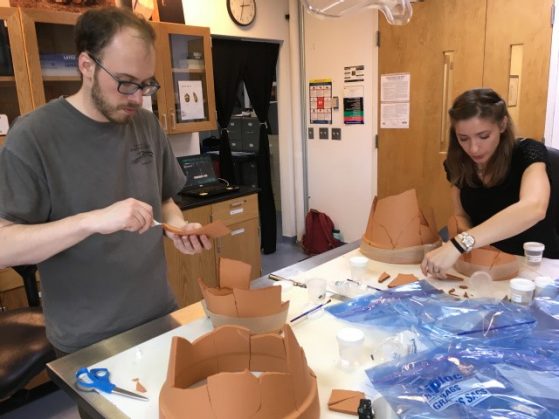Students reconstructing ceramic pots