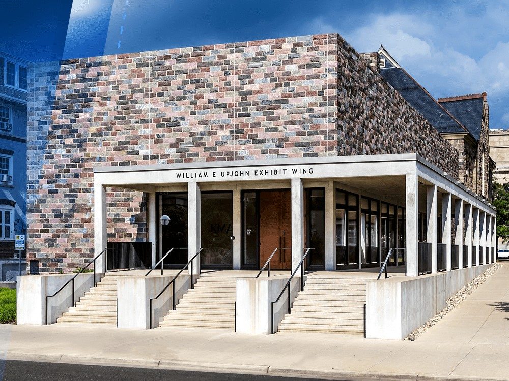 Exterior of the Kelsey Museum’s Upjohn Exhibit Wing, with a blue gradient overlaid.