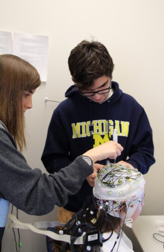 Two students working with an electrode cap