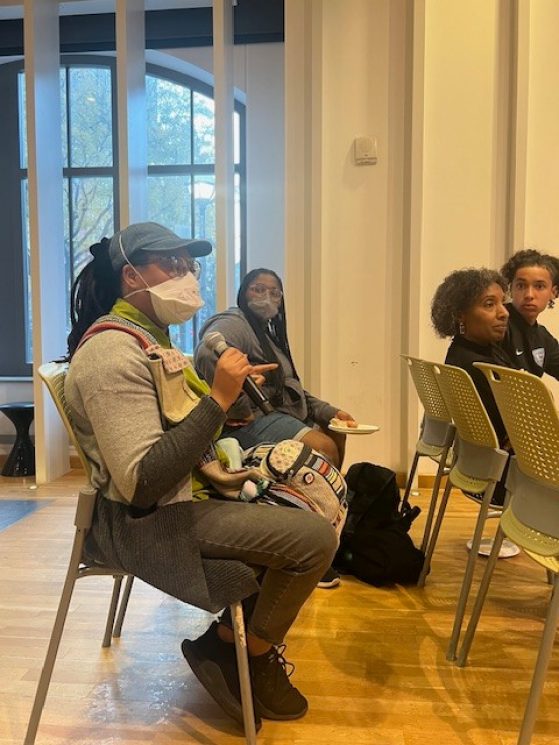 Student speaking into microphone at event