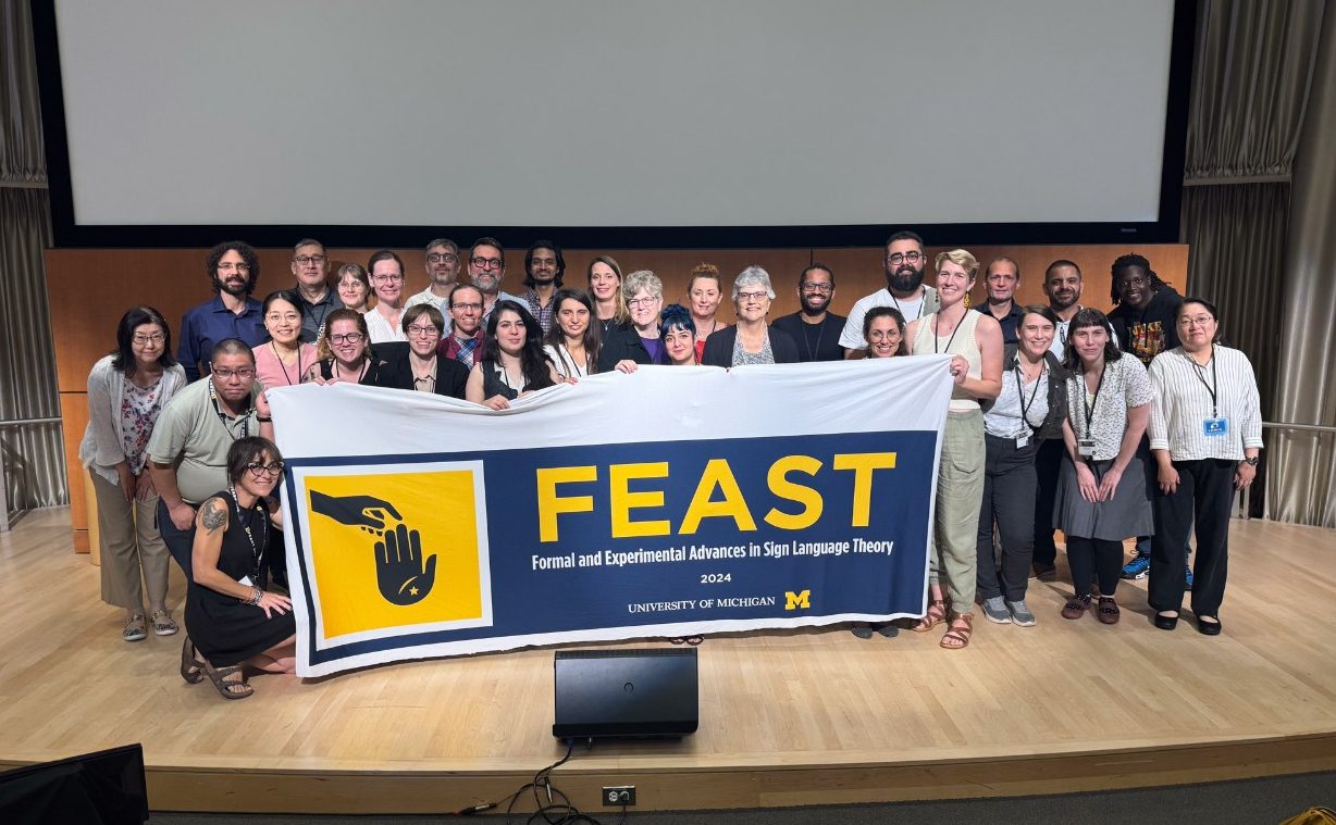 FEAST group photo on the conference stage