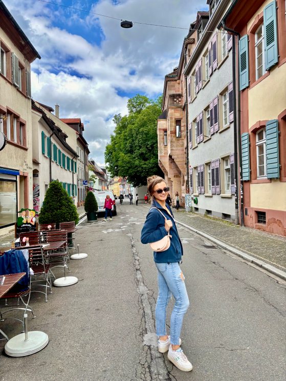 Student standing on old city street between buildings