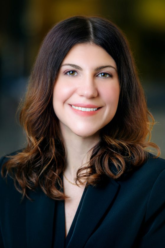 portrait of woman with dark hair wearing a dark blazer