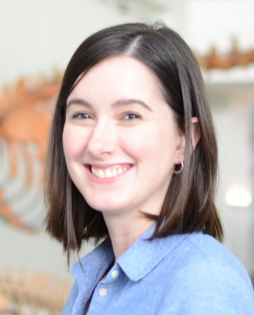 smiling brunettehaired woman in blue blouse 
