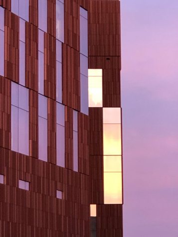 narrow window in the BSB light up against a purple sky at sunset