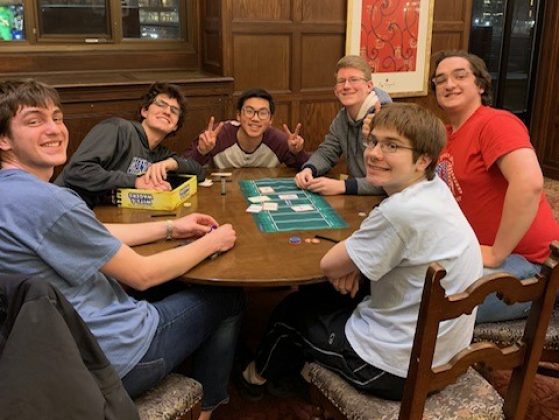 Group of students playing a board game in a lounge