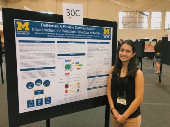 Sabrina Tobar Thommel posing in front of her research poster