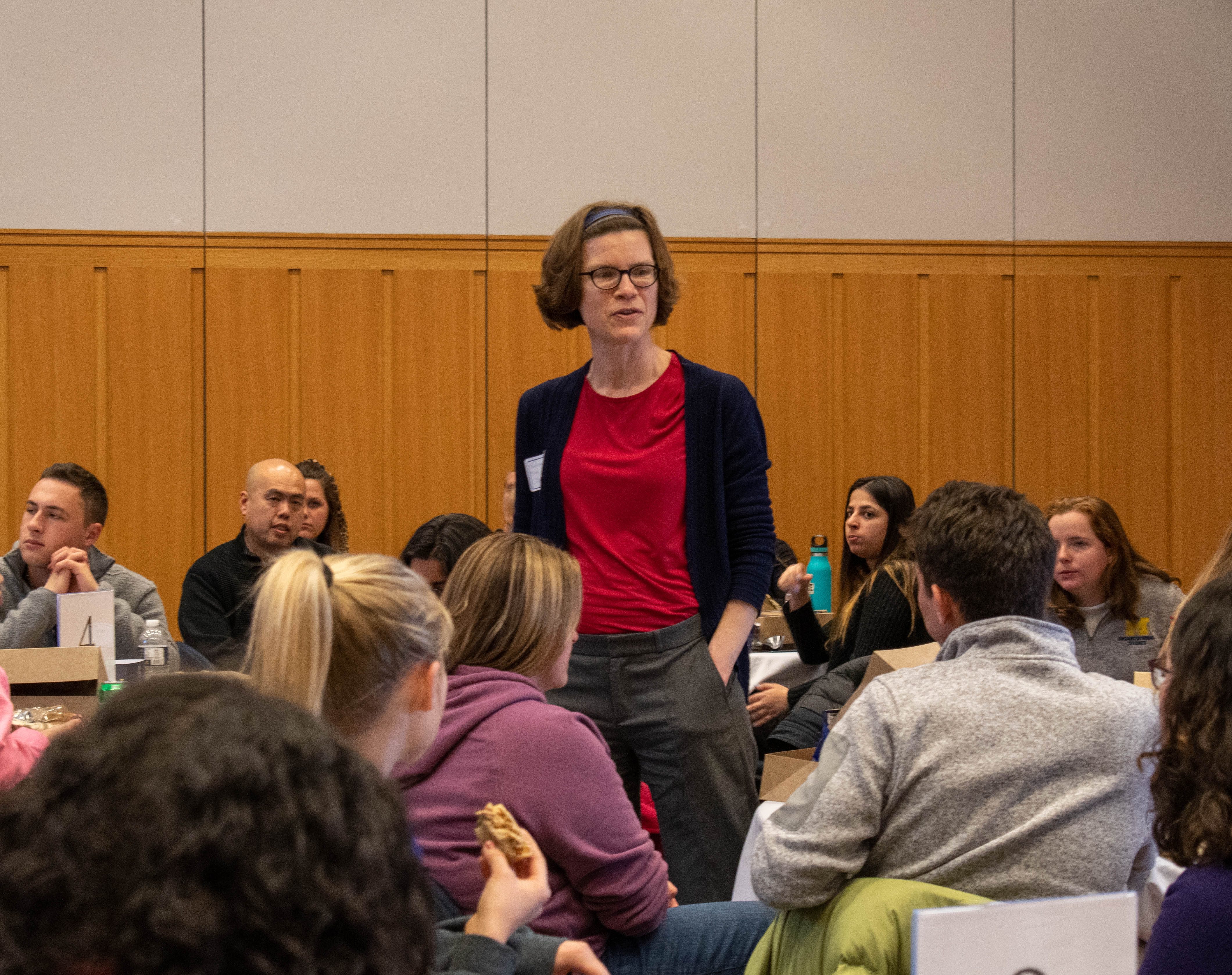 Beth Berman stands and introduces herself to newest cohort of OS admits at OS Orientation in 2019
