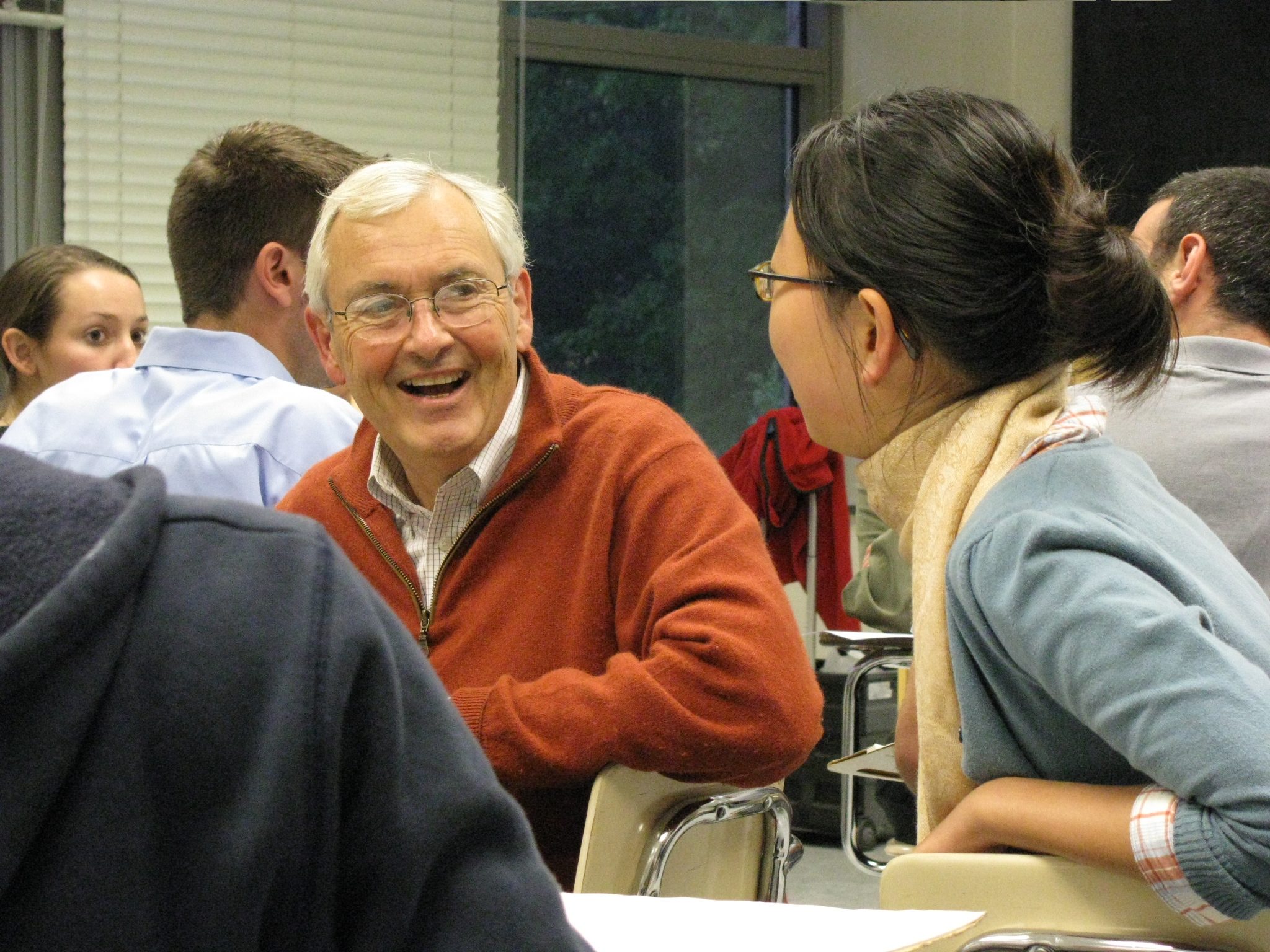 Rick Price laughing with OS student in an OS student discussion event