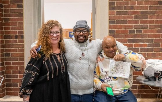 Group of three people smiling