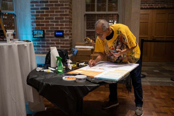 Artist, Martin, painting in yellow shirt