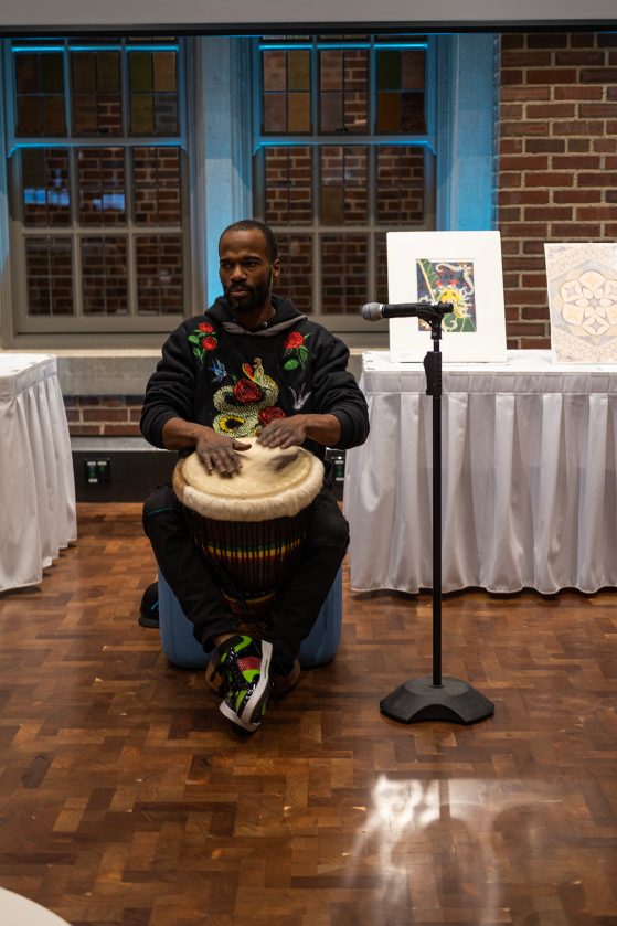 Musician, Calvin Green, playing the djembe; a West African drum