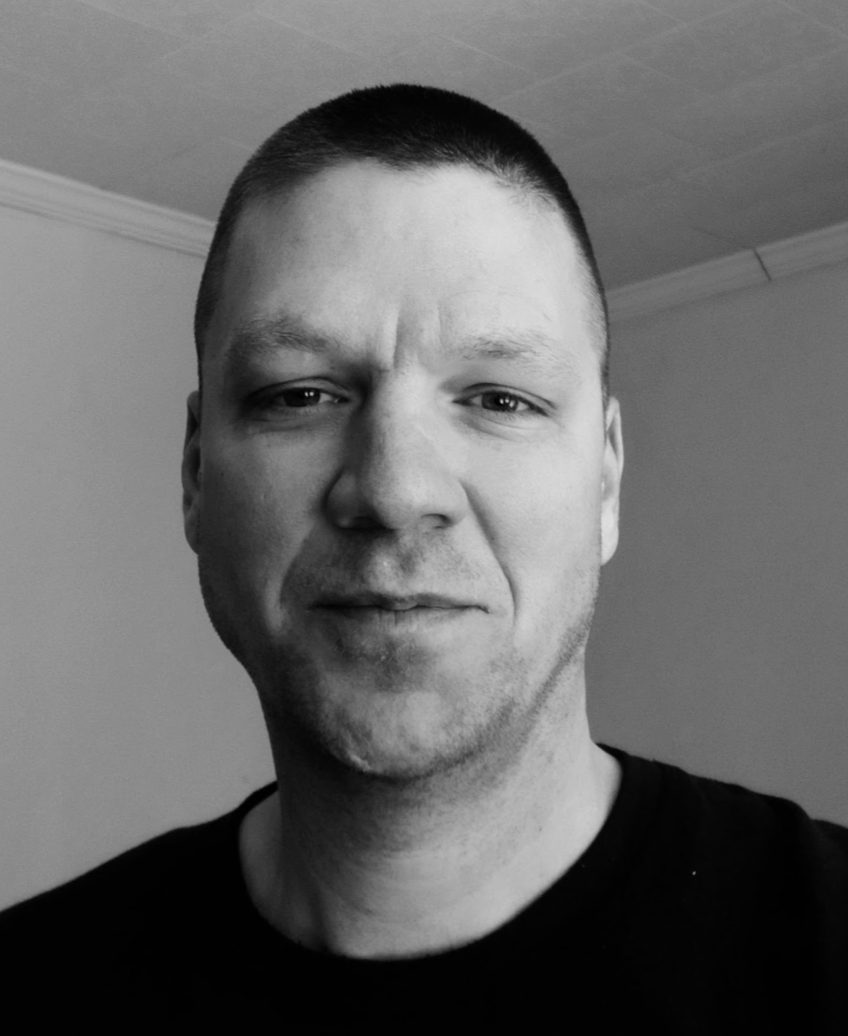 Black and white portrait of author, Rob Burg