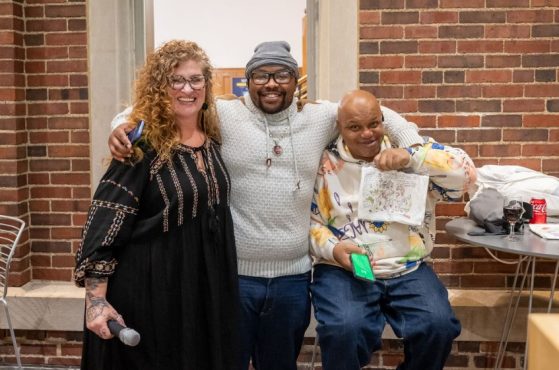 Group of three people smiling