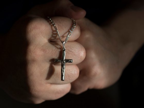 Hands holding a rosary