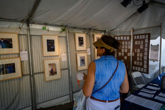 Person looking at artwork hanging on a wall