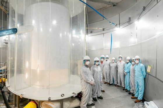 Researchers sit between two outer layers of LZ during construction.