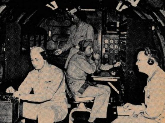 Paul M. Fitts (right) aboard a cargo aircraft during an airborne experiment in the late 1940s while serving as an Air Force lieutenant colonel.