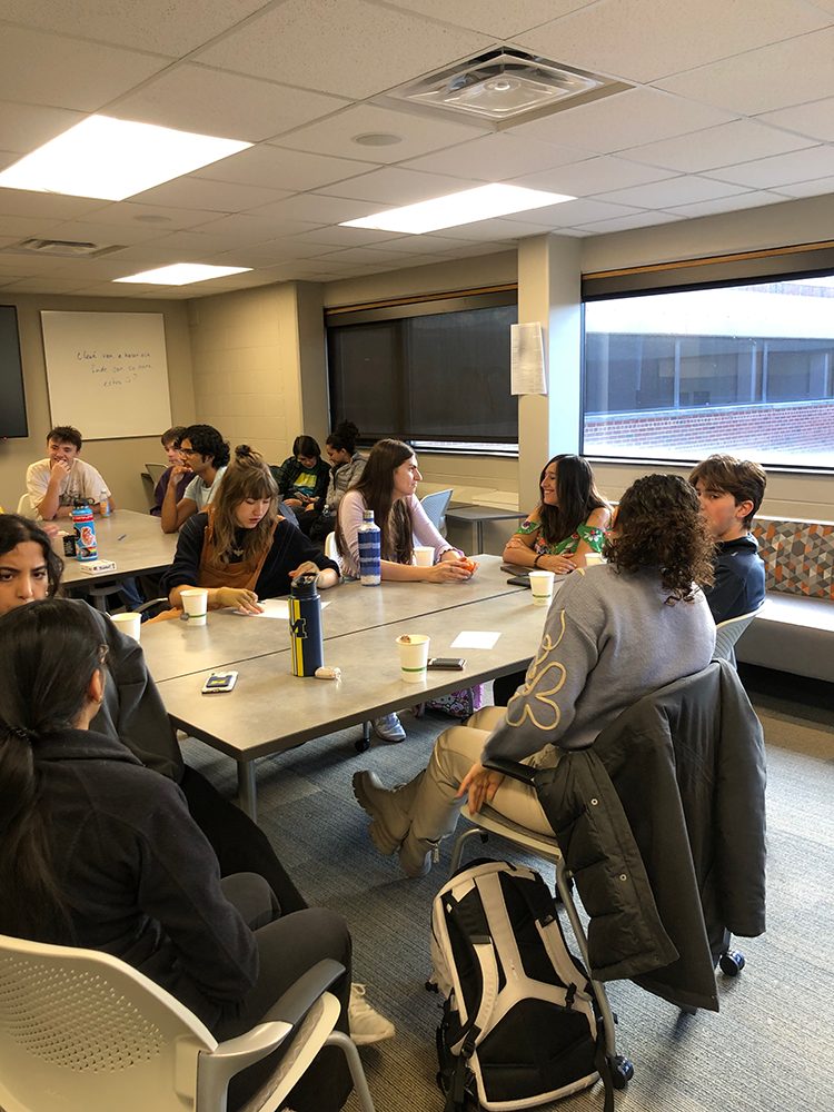 French Students chat around a table