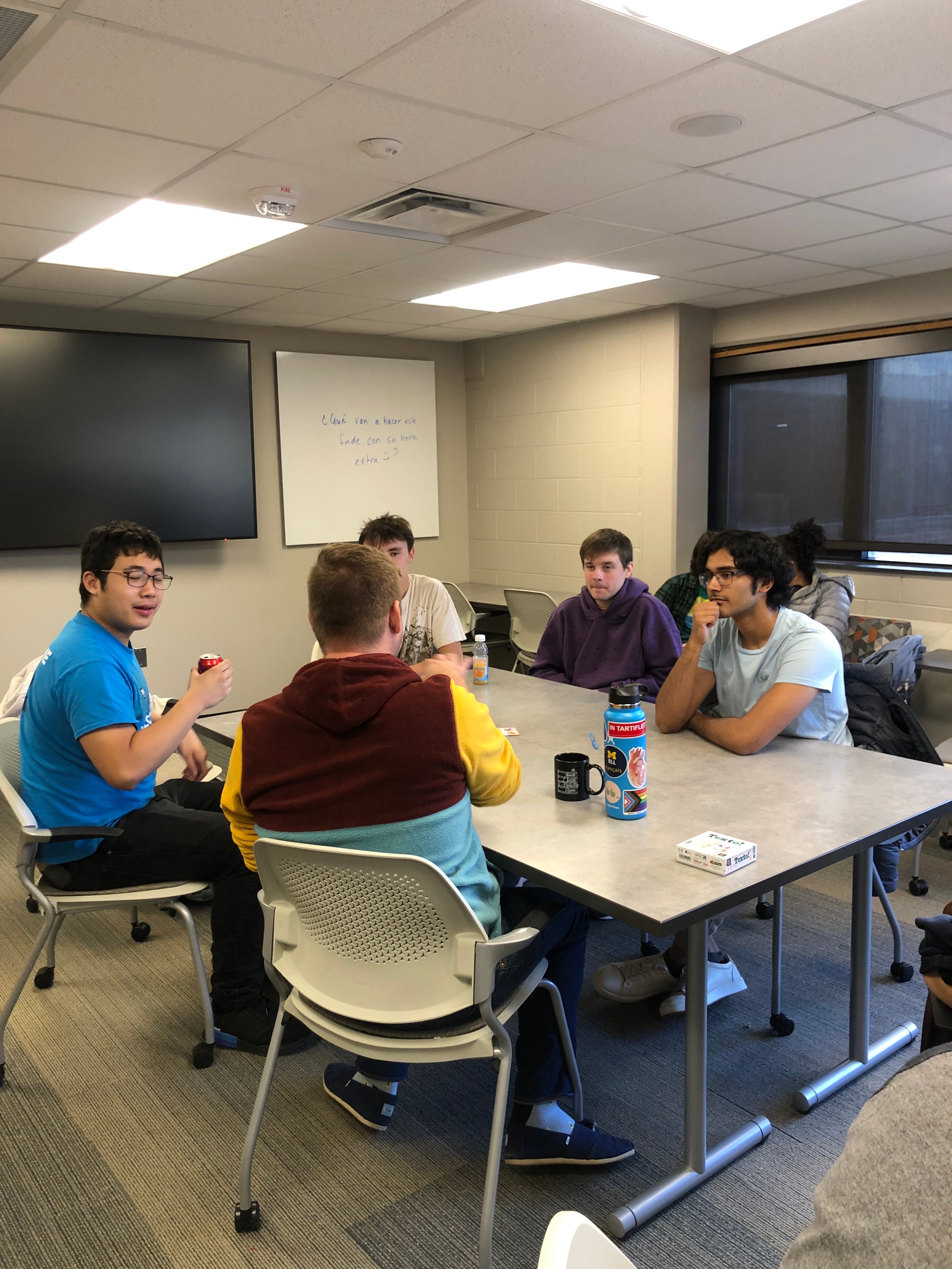 French Students chat around a table 