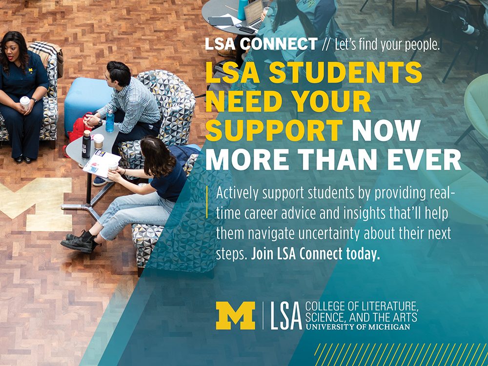 Students sit in a discussion around a block M