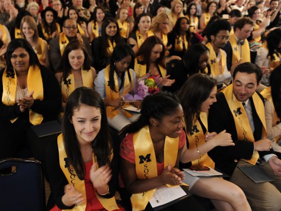 An overhead shot of a crowd of Sociology graduates clapping at a ceremony.