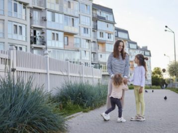 A woman and two children going for a walk outside