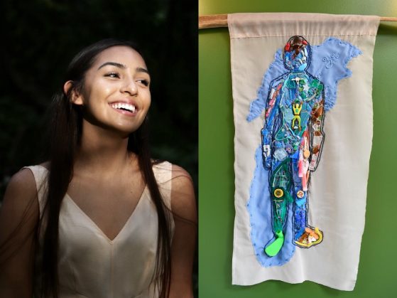 Woman smiling next to hanging art