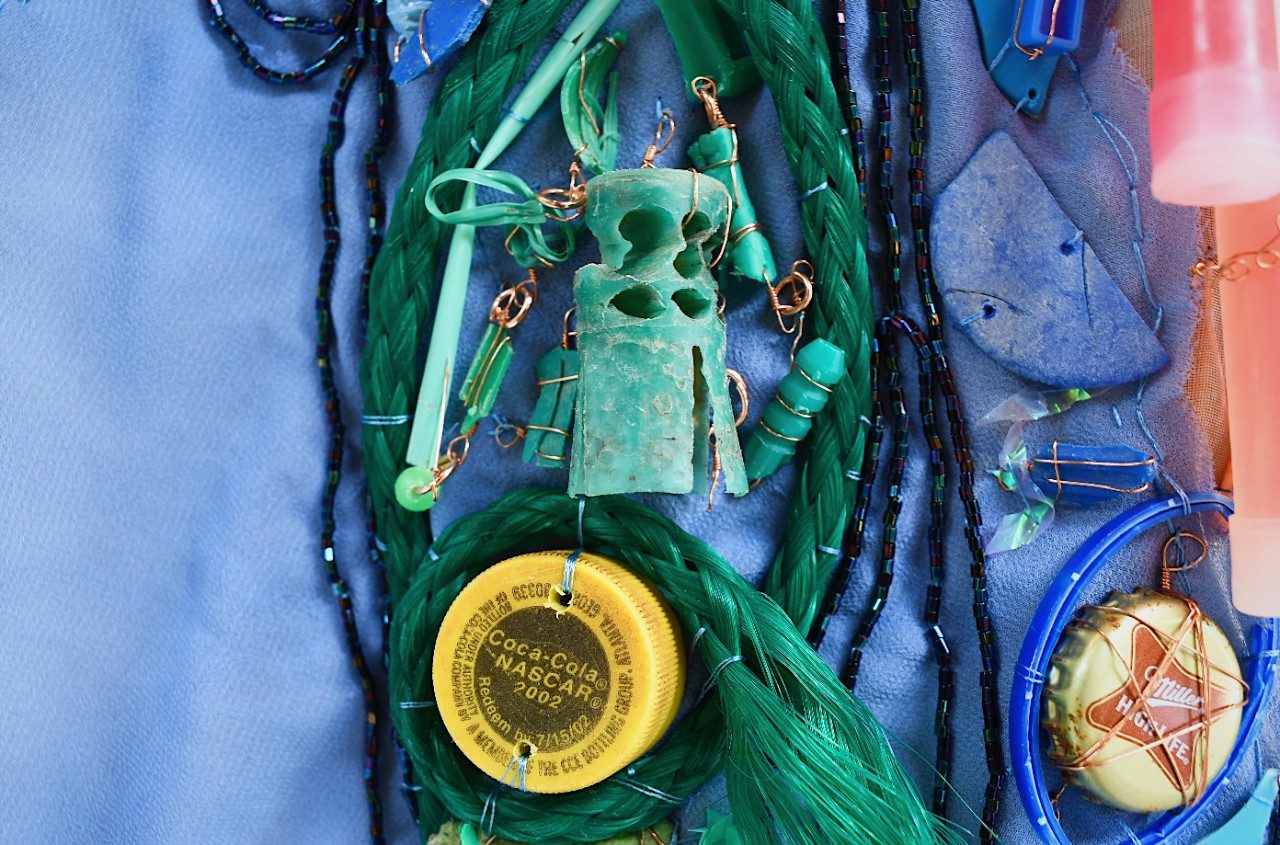 Plastic trash organized as art on a canvas