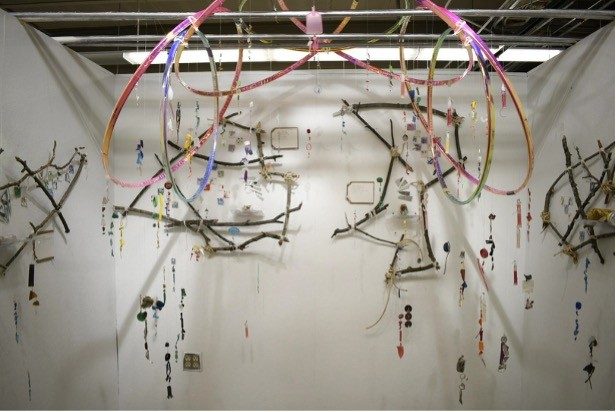 Plastic trash hanging as art from a ceiling