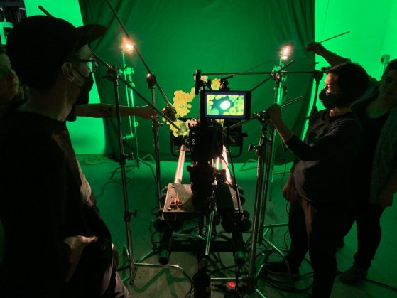 Green lit room with people