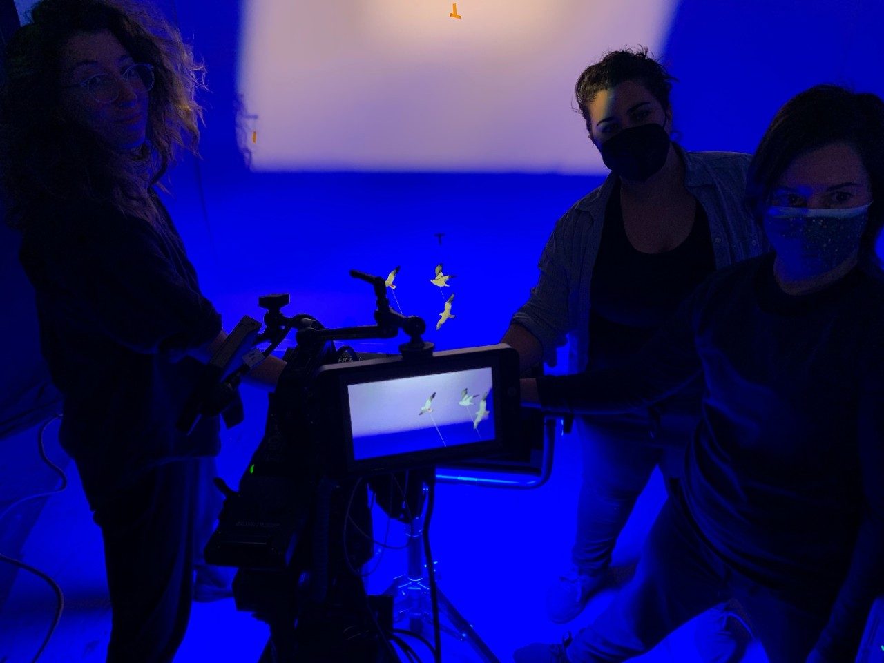 Blue lighted room with people