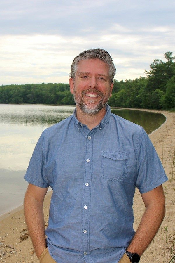 Man standing on the shore of a lake