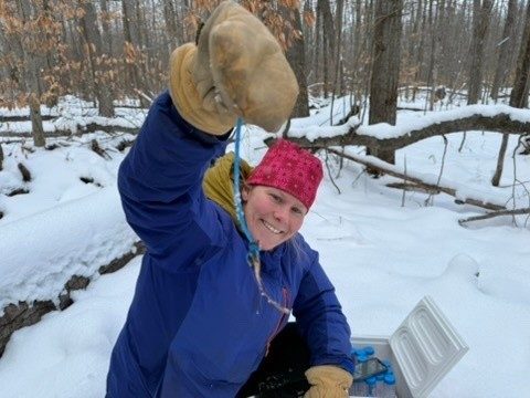 Person holding a resin strip in a snowy forest