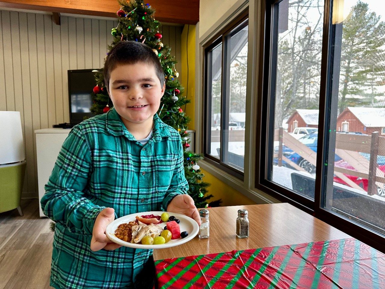 Boy holding a plate of food
